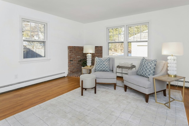 sitting room featuring light wood-style flooring and baseboard heating