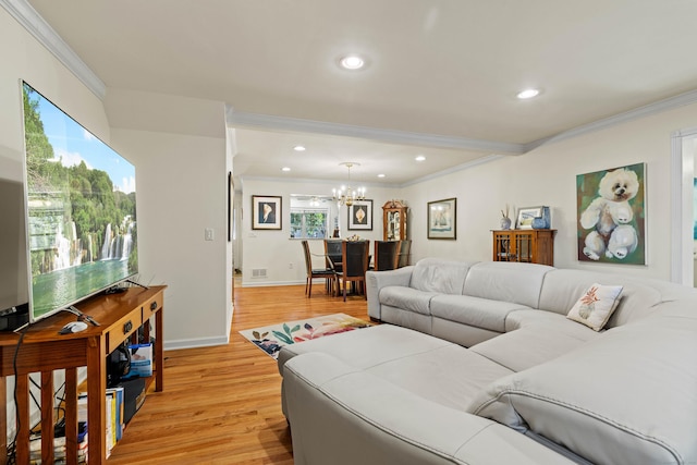 living room with light hardwood / wood-style flooring, crown molding, and a notable chandelier