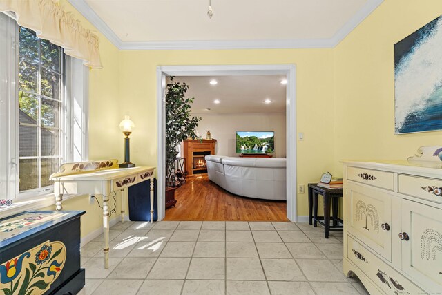 interior space featuring crown molding, a wealth of natural light, and light tile patterned floors