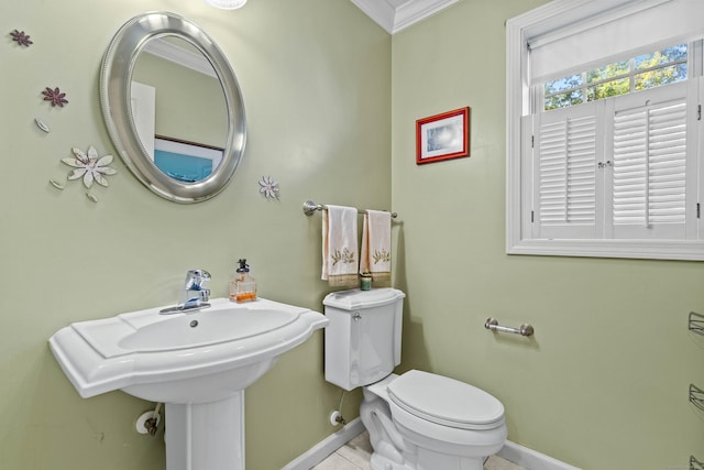 bathroom featuring ornamental molding and toilet