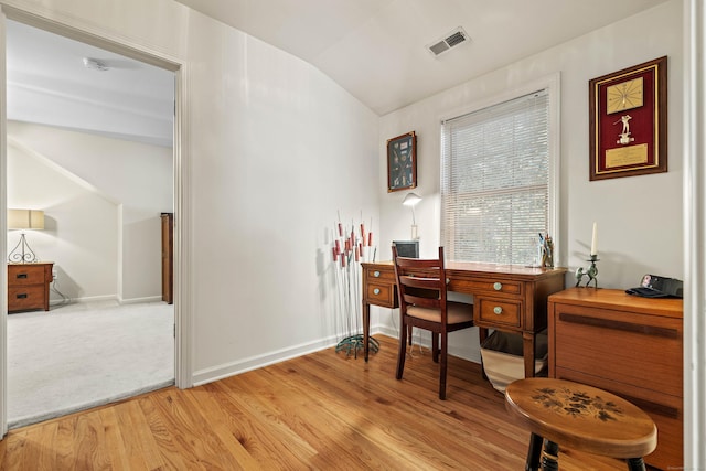 office area with light wood-type flooring and vaulted ceiling