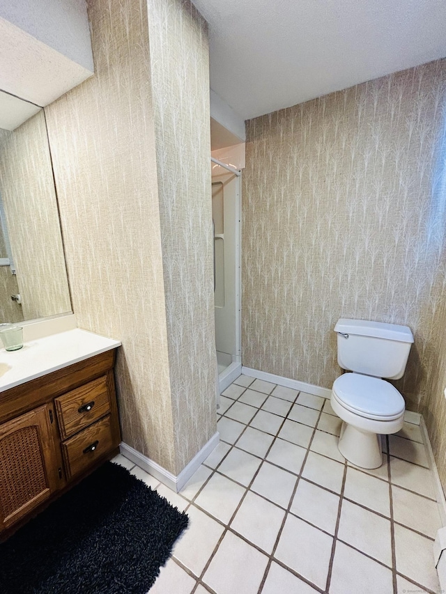 full bath featuring wallpapered walls, baseboards, toilet, vanity, and a walk in shower