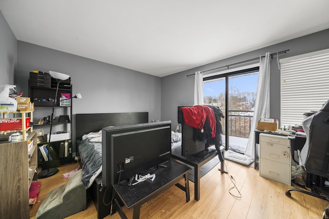 bedroom featuring light hardwood / wood-style floors and access to outside