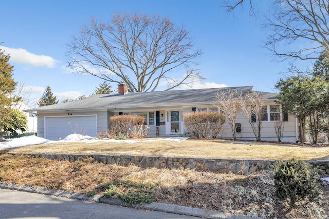 single story home with an attached garage, a chimney, and a front lawn