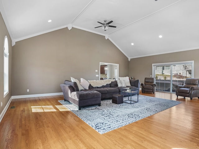 living area with vaulted ceiling with beams, crown molding, baseboards, and wood finished floors