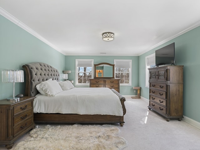 bedroom with baseboards, crown molding, and light colored carpet