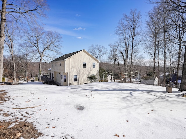 snow covered property featuring volleyball court