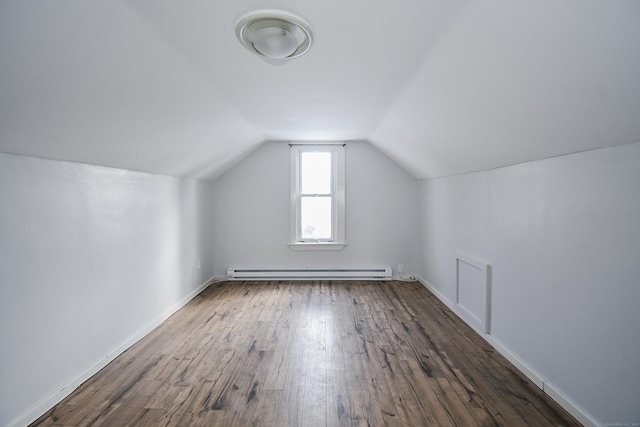 bonus room featuring lofted ceiling, dark wood-type flooring, and a baseboard heating unit