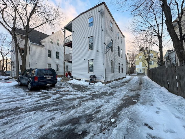 view of snowy exterior featuring a balcony