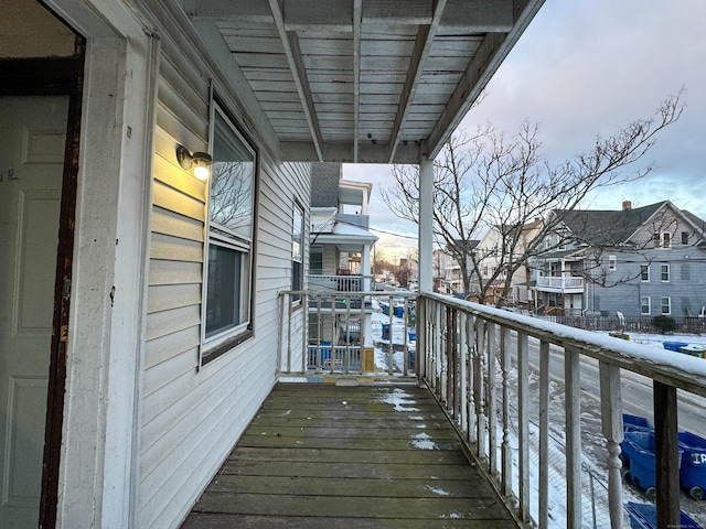 view of snow covered back of property