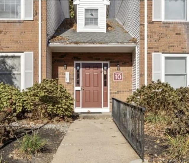 entrance to property with brick siding