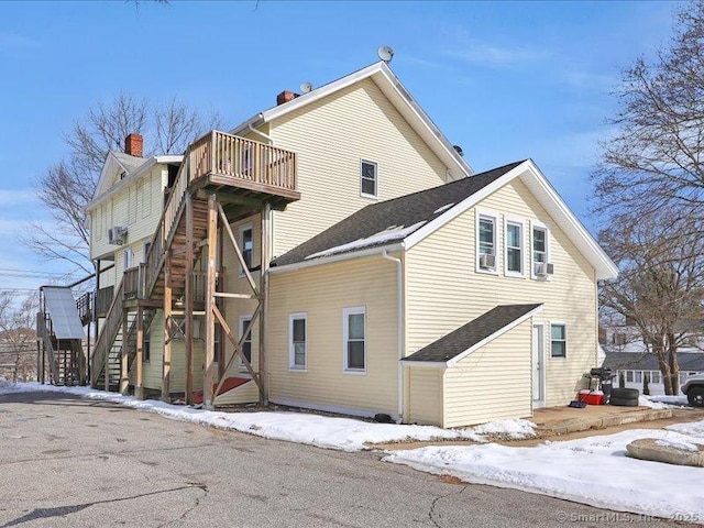 view of snow covered exterior featuring stairway