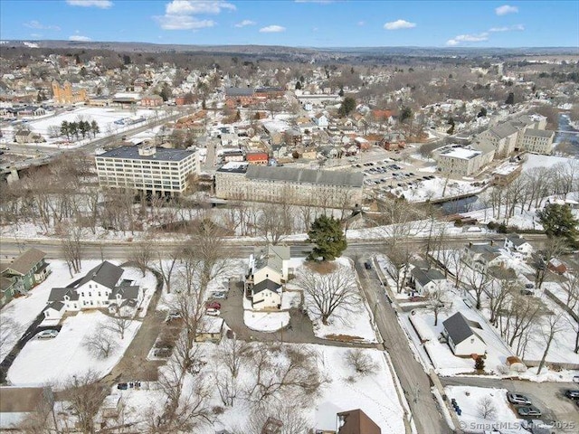 snowy aerial view featuring a residential view