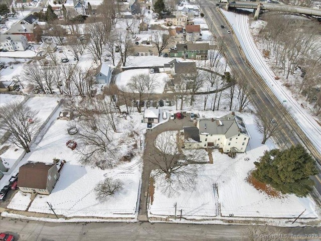 snowy aerial view featuring a residential view