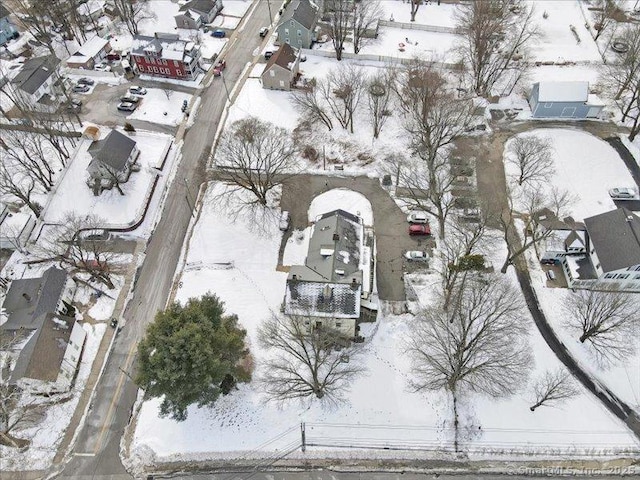 snowy aerial view with a residential view