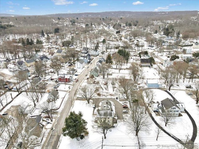 snowy aerial view featuring a residential view