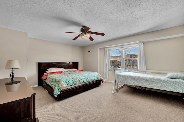 bedroom featuring a textured ceiling, carpet, a ceiling fan, and baseboards