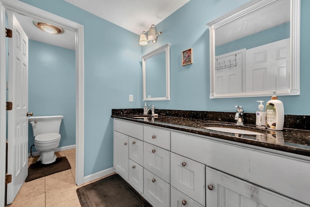 full bath with tile patterned flooring, a sink, toilet, and double vanity