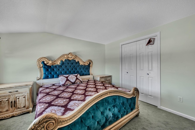 carpeted bedroom with a closet, vaulted ceiling, a textured ceiling, and baseboards