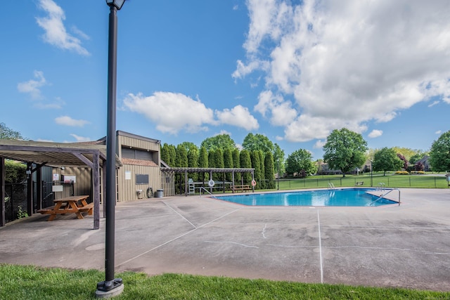 pool with fence, a pergola, a lawn, and a patio