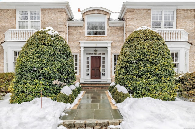 view of snow covered property entrance