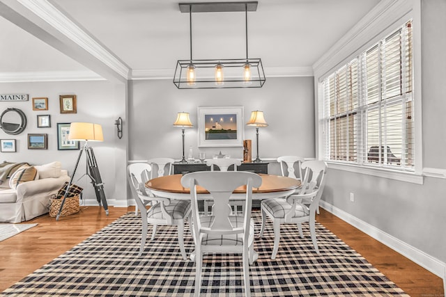 dining room with ornamental molding and hardwood / wood-style floors