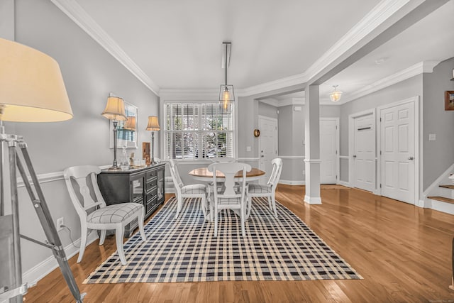 dining room with ornamental molding and wood-type flooring