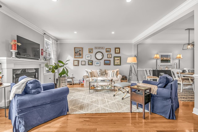 living room with hardwood / wood-style flooring and crown molding