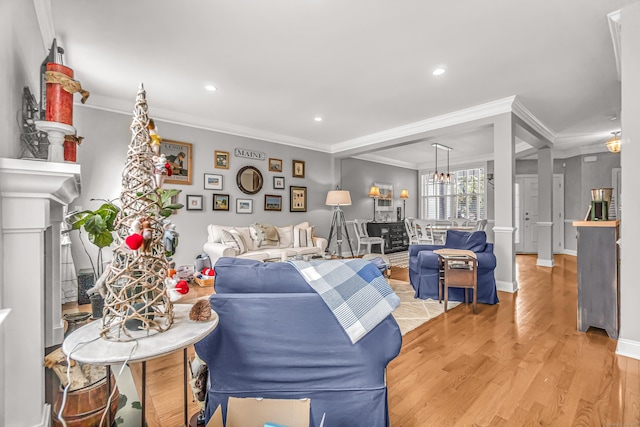 living room with ornamental molding and hardwood / wood-style floors