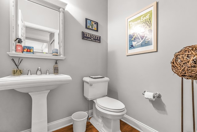 bathroom with sink, toilet, and hardwood / wood-style floors