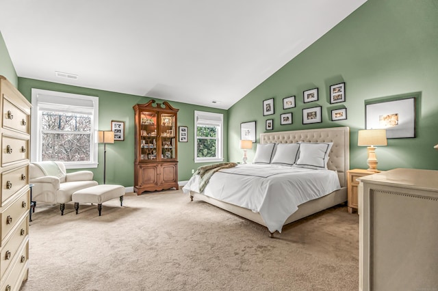 bedroom with light carpet and lofted ceiling