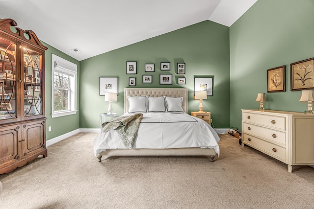 bedroom with vaulted ceiling and light colored carpet