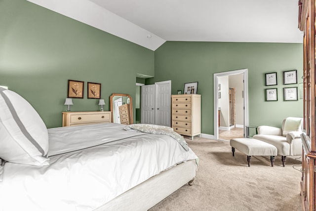 carpeted bedroom featuring lofted ceiling