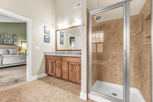 bathroom featuring tile patterned floors, an enclosed shower, and vanity