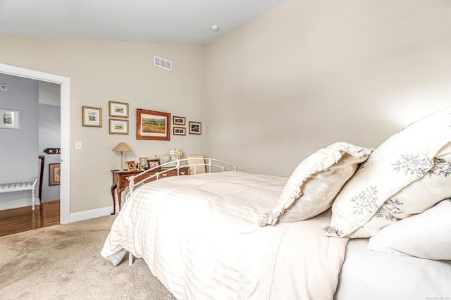 bedroom featuring carpet flooring and lofted ceiling