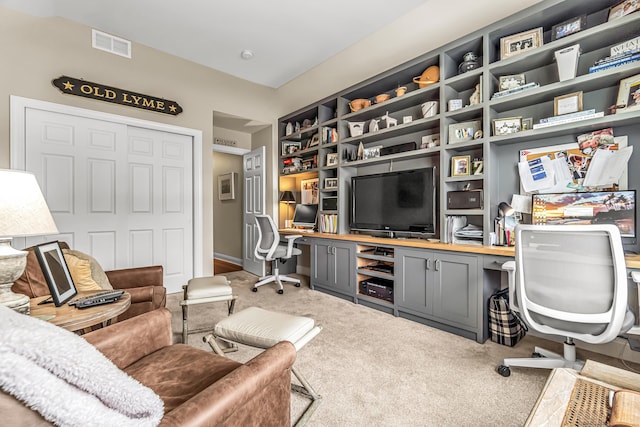 office with built in desk and carpet floors