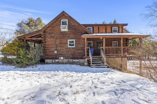 view of front facade with covered porch and log exterior