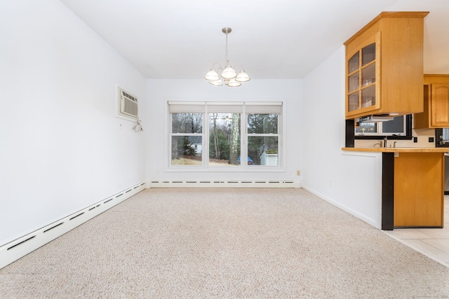 kitchen with a notable chandelier, light colored carpet, baseboard heating, glass insert cabinets, and a wall mounted air conditioner