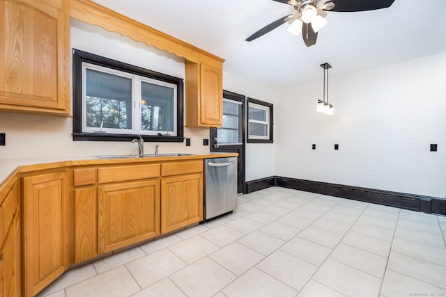 kitchen featuring baseboards, dishwasher, a ceiling fan, light countertops, and a sink