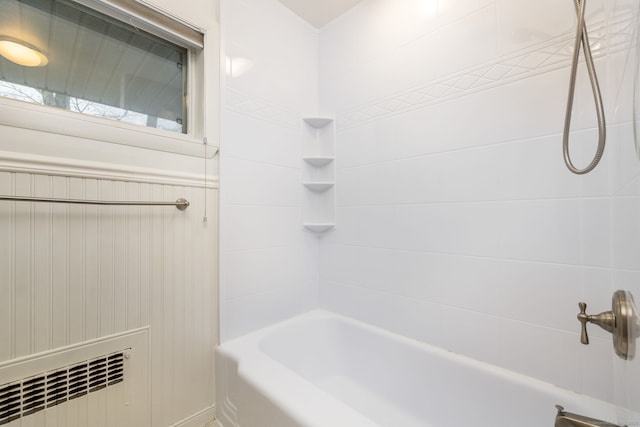 bathroom with radiator heating unit and shower / washtub combination