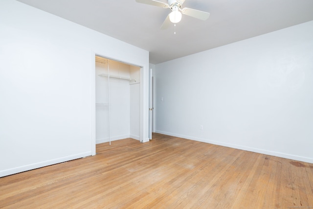 unfurnished bedroom with a closet, baseboards, ceiling fan, and light wood finished floors