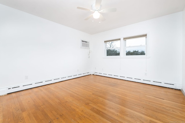 empty room with a baseboard radiator, light wood finished floors, a wall mounted air conditioner, and a ceiling fan