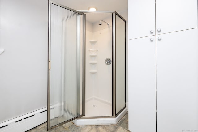 full bath with a baseboard heating unit and a stall shower