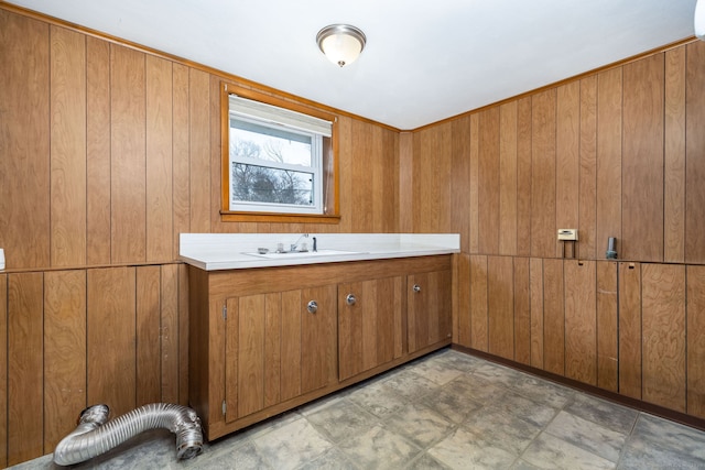 interior space featuring wood walls, vanity, and tile patterned floors