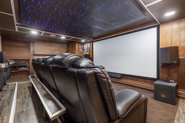 home theater featuring wood walls, wood finished floors, and recessed lighting