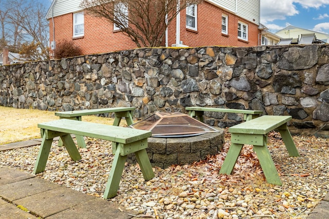 view of community with an outdoor fire pit