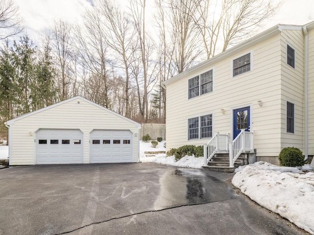 view of front of property featuring a detached garage and an outdoor structure