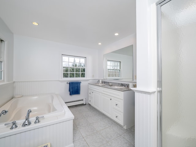 full bathroom with double vanity, a baseboard radiator, a sink, and wainscoting