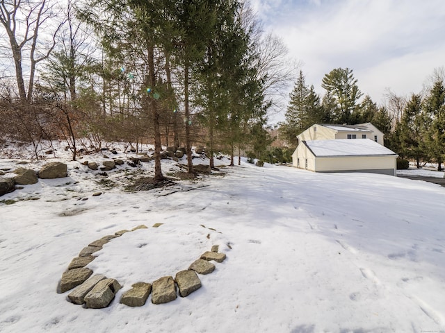 yard covered in snow with a garage