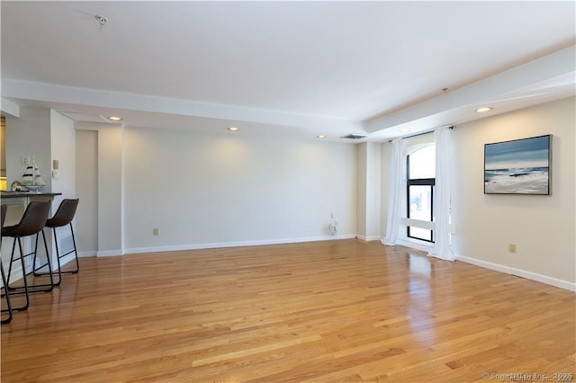 empty room featuring visible vents, recessed lighting, baseboards, and light wood finished floors